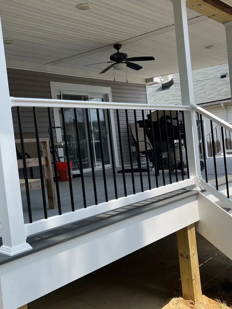 Covered deck with railings.