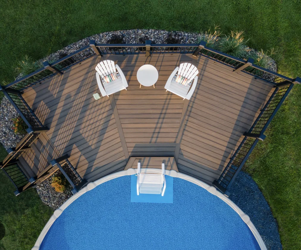 Aerial view of a composite pool deck with Adirondack chairs