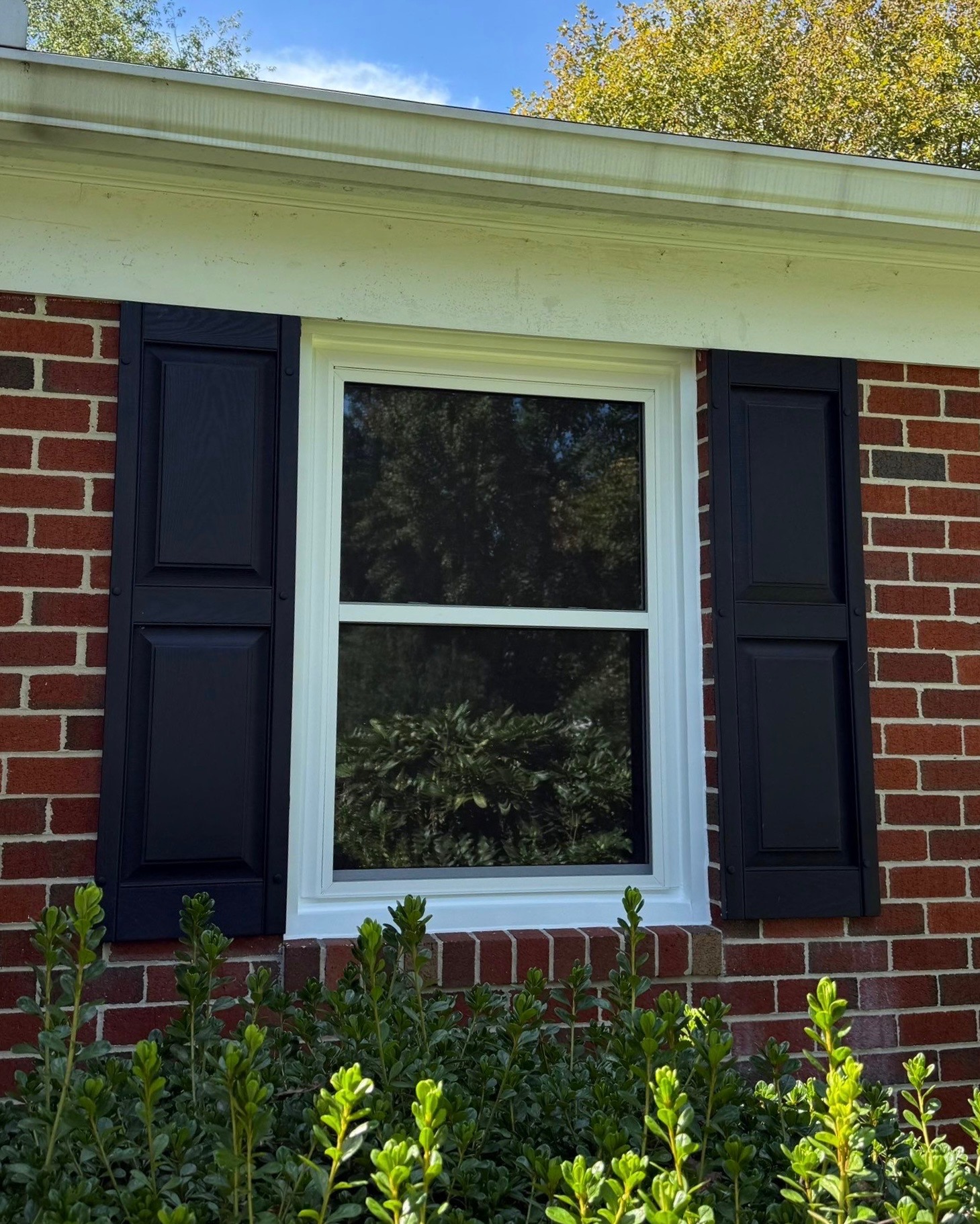 White Alside Mezzo double-hung window installed on a brick home in Ellicott City, Maryland.