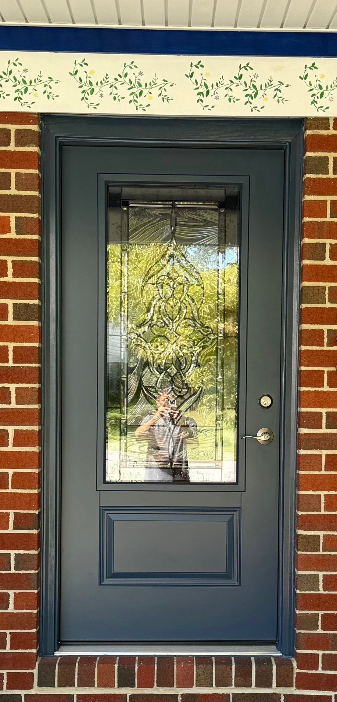 Exterior view of a ProVia Legacy smooth steel entry door in Enzian Blue with decorative glass.