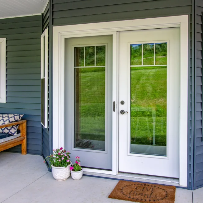 Legacy 460 smooth hinged patio door in white with internal grids.