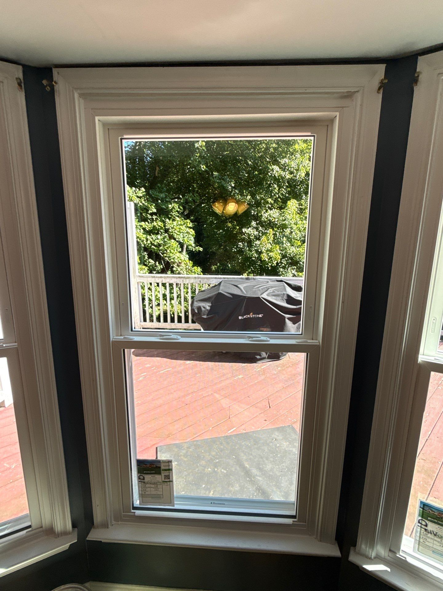 Bay window before and after replacement with a white ProVia Aspect double-hung window in Sykesville, Maryland