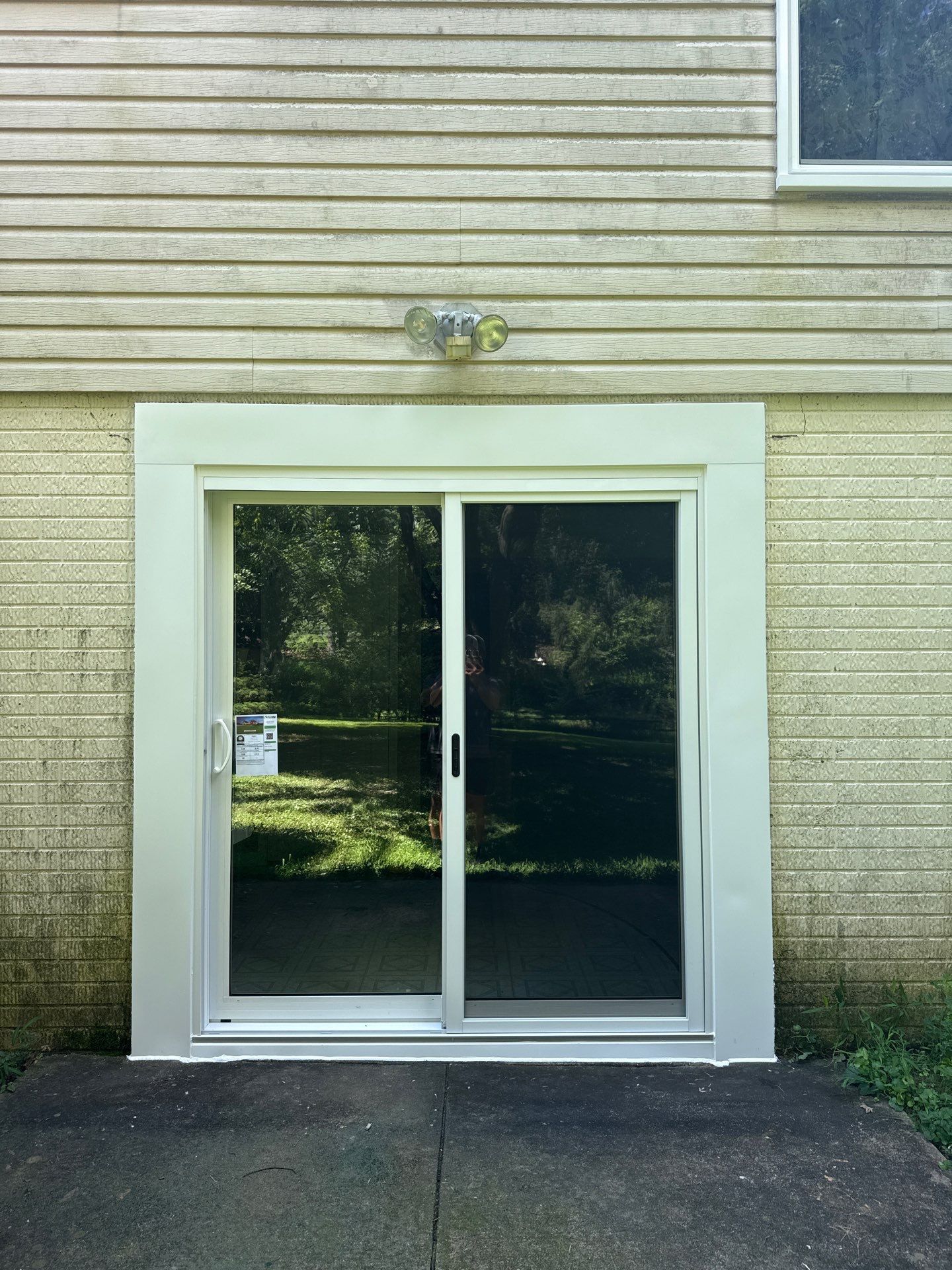 Lower patio doors before and after replacement with a white ProVia Aspect sliding patio door in Sykesville, Maryland