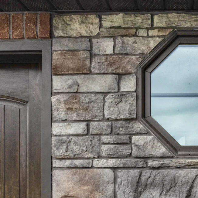 ProVia Aeris wood-look window in rustic bronze with cottage grids.